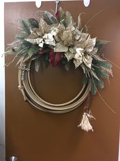 a christmas wreath hanging on the wall next to a door