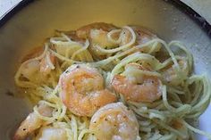 shrimp and pasta in a skillet ready to be cooked on the stove or used as an appetizer