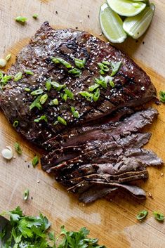 the steak is sliced up and ready to be served on the cutting board with garnishes