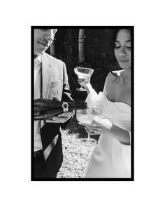 a man and woman holding wine glasses in their hands