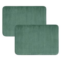 two green placemats sitting on top of each other