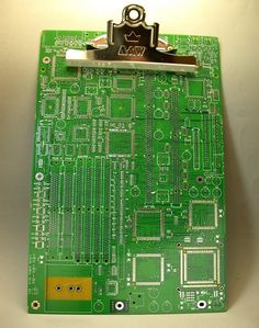 a clipboard that has been made into a piece of circuit board with metal clips attached to it