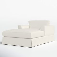 a white couch sitting on top of a white floor