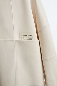 a white jacket with a label on it