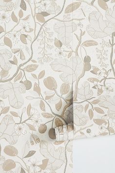 the wallpaper is decorated with flowers and leaves in neutrals, beiges and browns