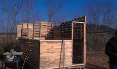 a man standing next to a truck filled with wooden crates