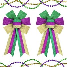 two purple and green bows with beads on the bottom one is for mardi gras