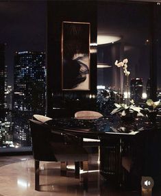 an elegant dining room with city lights in the background