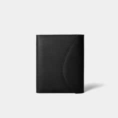 a black leather wallet with a curved design on the front and side, against a white background