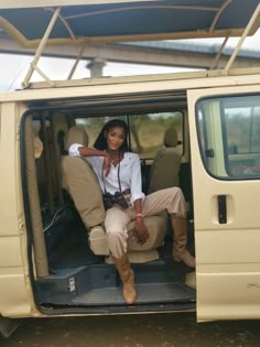 a woman sitting in the back of a van