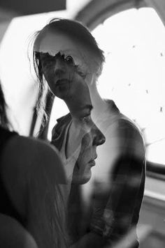 black and white photograph of two women looking at their cell phones in front of them