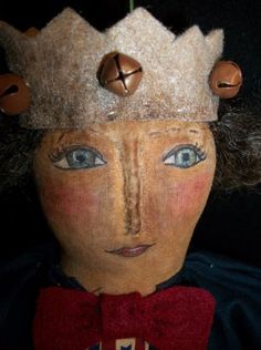 a wooden doll with a crown on it's head