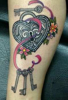 a tattoo on the leg of a woman with keys and flowers attached to her thigh