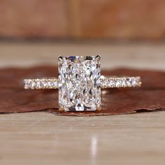 Radiant cut diamond ring with pave diamonds in yellow gold, featuring hidden halo engagement ring design and claw prongs Radiant Cut Diamond Ring, Radiant Halo, Moissanite Vs Diamond, Hidden Halo Engagement Ring, Ring Inspiration, Radiant Cut Engagement Rings, Colored Diamond Rings, Pave Diamond Band, Super Nails