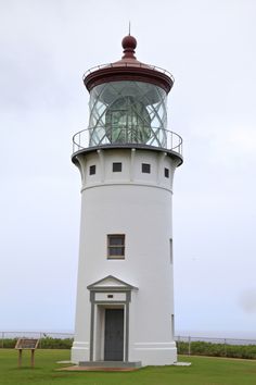 there is a white lighthouse with a glass top