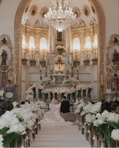 the bride and groom are sitting at the alter