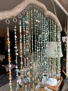 a wind chime with beads hanging from it's side on top of a table