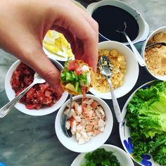 a person is spooning food out of small bowls