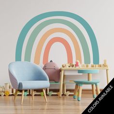 two children's chairs in front of a wall with a rainbow painted on it