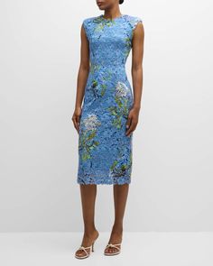 a woman wearing a blue dress with flowers on it