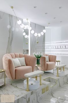 a living room with marble floors and pink couches in front of a large mirror