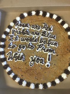 a cookie cake with writing on it in a box