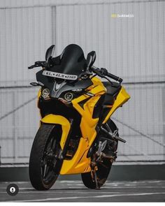 a yellow motorcycle parked in front of a building