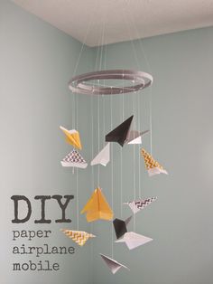 a mobile made out of paper airplanes hanging from the ceiling in a child's room