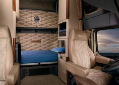 the inside of an rv with leather seats and mattresses