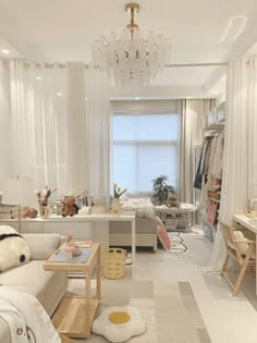 a living room filled with furniture and a chandelier