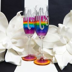 two wine glasses with the word happily painted on them, sitting next to each other