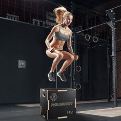 a woman doing squats on top of a box