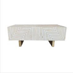 a white table with an interesting design on the top and legs, in front of a white background