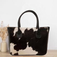 A 100% handmade cowhide shoulder bag typically stands out for its durability, natural texture, and timeless design. Crafted from premium cowhide leather, it often features rich grain patterns, ensuring each bag is unique. Handmade construction also means attention to detail, with careful stitching and possibly hand-burnished edges. Here are a few typical features: *Material: Full-grain and cowhide leather, which develops a patina over time. *Straps: Adjustable or fixed-length shoulder strap, often reinforced for added strength. *Interior: May have compartments for organization, often lined with soft fabric or leather. *Closure: zipper. *Design: Minimalistic, rustic, or contemporary, depending on the artisan. *Size: Height: 12 inches, Width: 15.5-inch, Strap length: 2 feet, Bottom: 4 inches Chic Handbags, Natural Texture, Last Minute Gifts, Cowhide Leather, Purses And Handbags, Soft Fabric, Soft Fabrics, Timeless Design, Patina