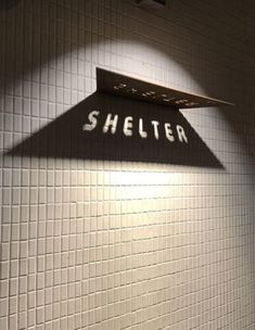 there is a sign that says shelter on the wall