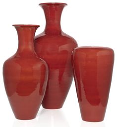 three red vases sitting next to each other