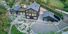 an aerial view of a house in the middle of a yard with trees and bushes