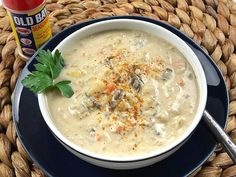 a bowl of soup is on a blue plate