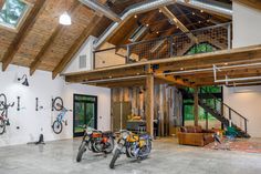 two bikes are parked in the middle of a large room with high ceilings and wooden beams