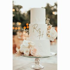 a white wedding cake sitting on top of a table