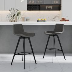 two gray bar stools sitting in front of a counter