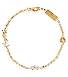 Complete your look the Saint Laurent way with the Opyum Heart charm bracelet. It features the label's logo plaque, YSL monogram, a crystal, and a heart charm evenly spaced along the golden curb chain. material: brass pendant: glass lobster-clasp fastening Made in Costa Rica Ysl Charm Bracelet, Ysl Bracelet Gold, Ysl Bracelet, Ysl Jewelry, Golden Bracelet, Gold Charm Bracelet, Dope Jewelry, Expensive Jewelry, The Saint