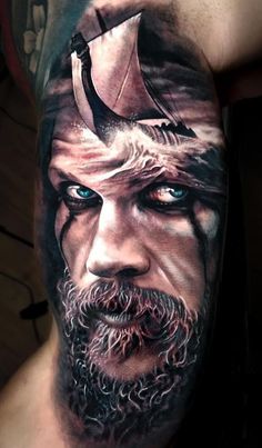 a man with a viking helmet on his head is shown in this artistic tattoo design