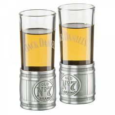 two old no 7 whiskey glasses sitting next to each other