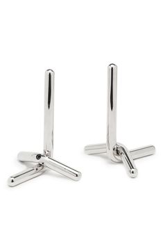 two pairs of silver cufflinks on a white background