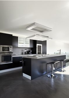 a modern kitchen with stainless steel appliances and counter tops