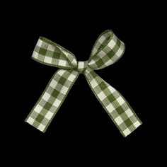 a green and white checkered bow on a black background