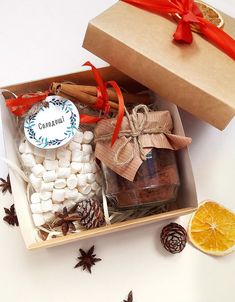 a box filled with marshmallows, orange slices and cinnamon