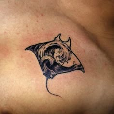 a woman's chest with a tattoo on it