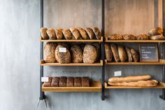 breads and loaves on shelves in a bakery